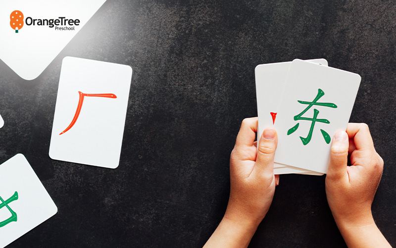 Child learning Chinese characters with flashcards.