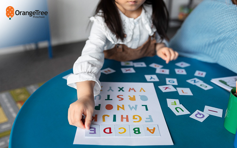 Child learning letters, building primary school readiness.