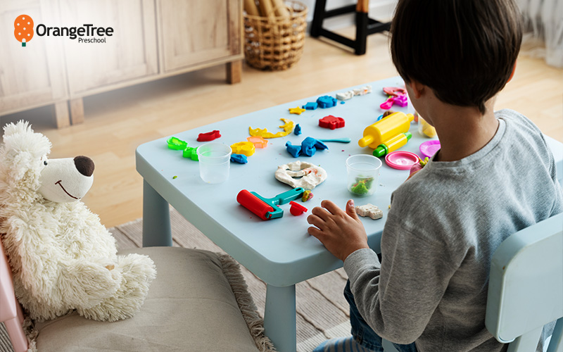 Child playing with play-doh for sensory exploration.