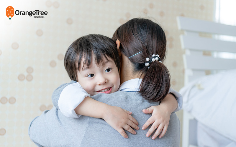 Happy child hugging parent, part of daily preschool routine.