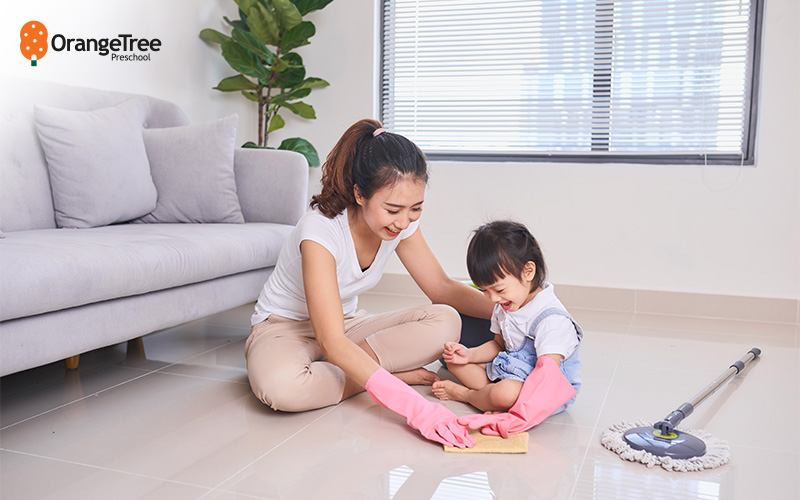 Parent and child cleaning the floor together.