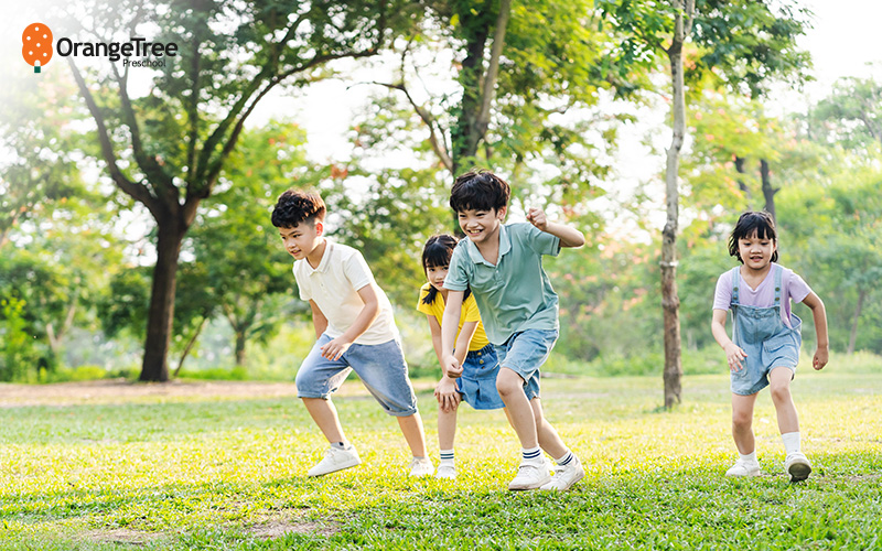 Preschoolers running and playing outdoors.