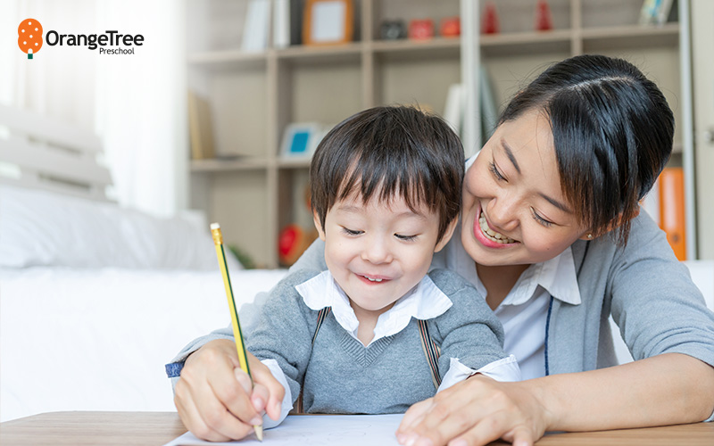 Teacher helping a child learn to write.