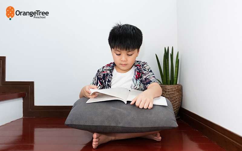 child reading by the stairs